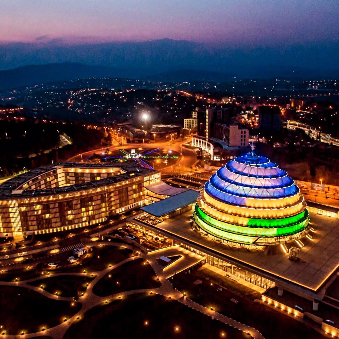 Kigali Convention Centre glowing above the city at night